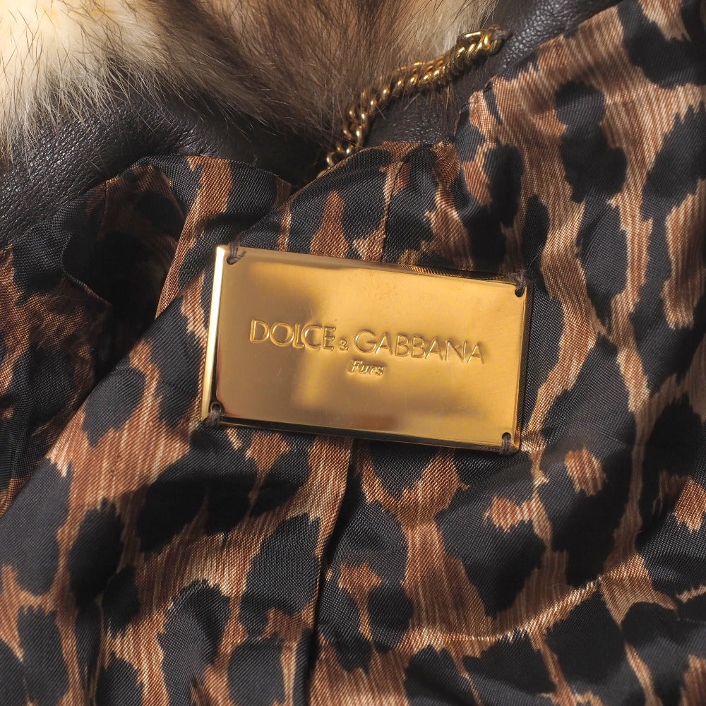 Dolce & Gabbana hooded jacket of brown leather and polecat fur, with goldtone logo buckle closures Size 38 –
